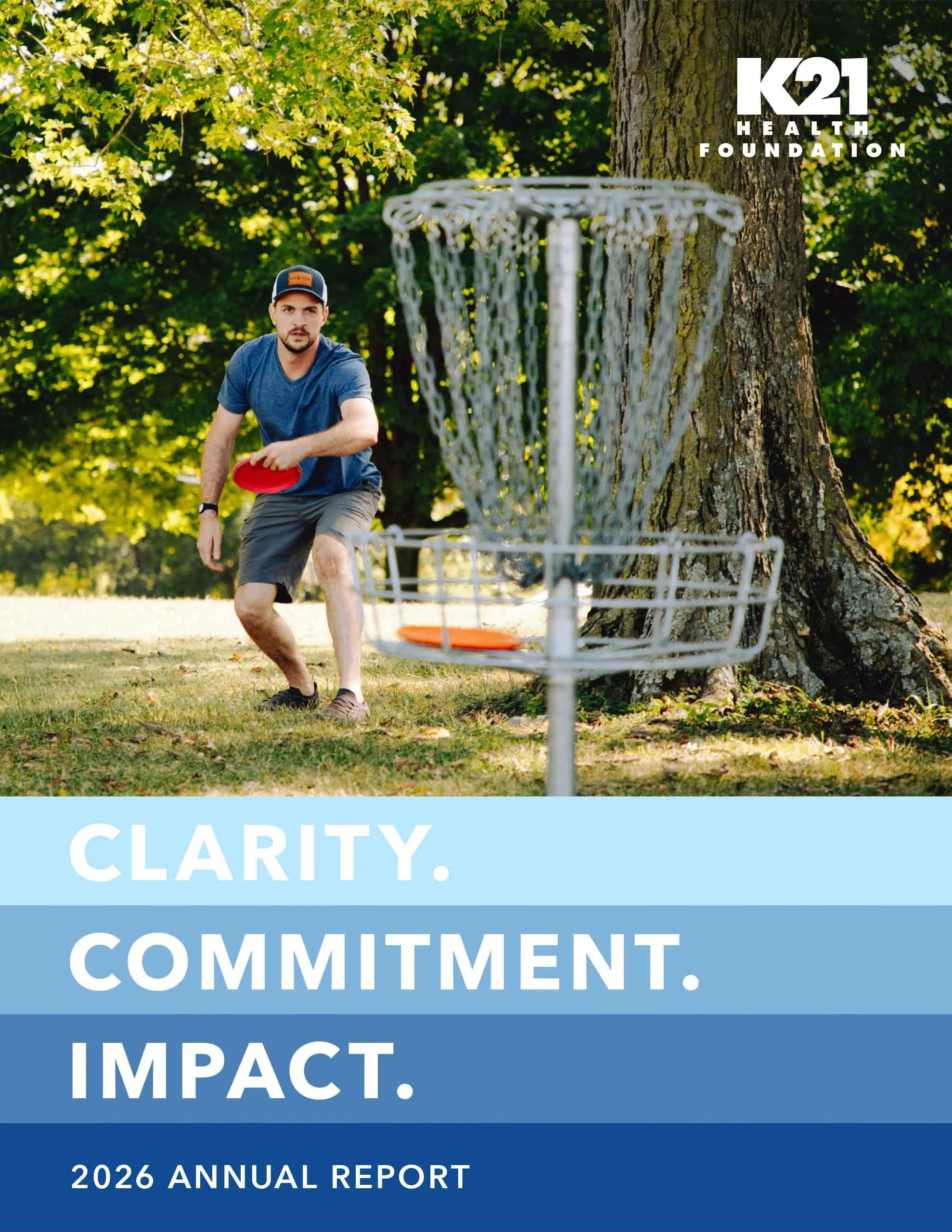 K21's 2026 Annual Report cover featuring man playing disc golf and the title "CLARIY. COMMITMENT. IMPACT."