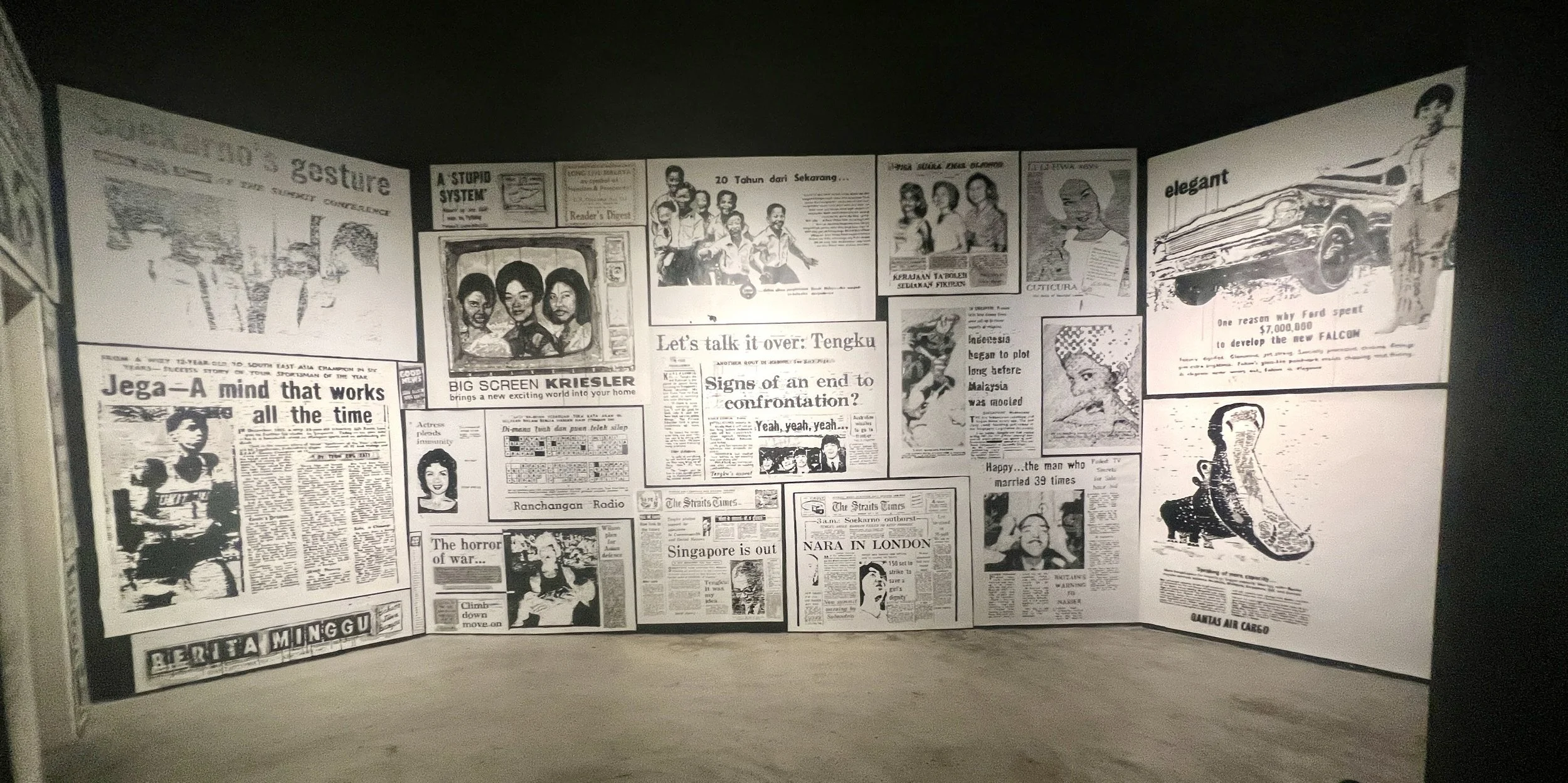 A wall covered with black and white vintage newspaper clippings and articles.