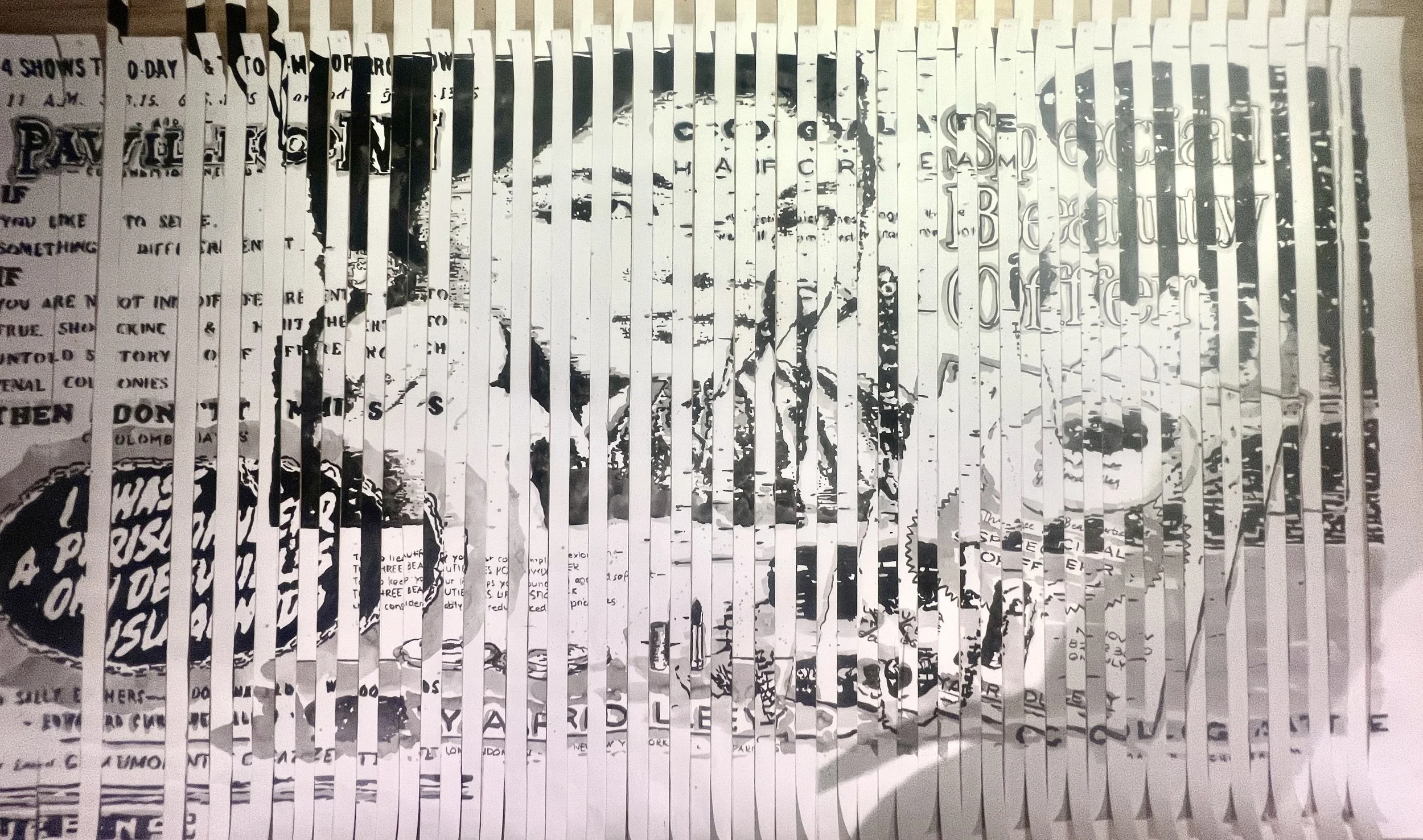 Black and white photo of a person's face, with long hair, behind a fence or grille made of vertical strips.