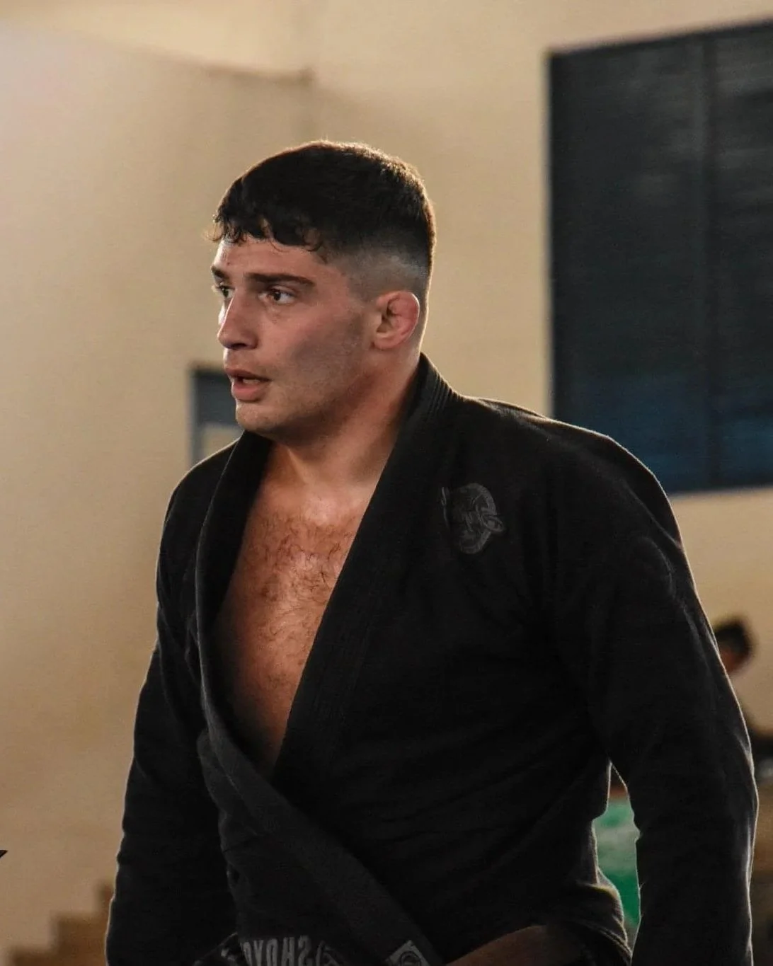 Coach Nacho wearing a black Brazilian Jiu-Jitsu gi