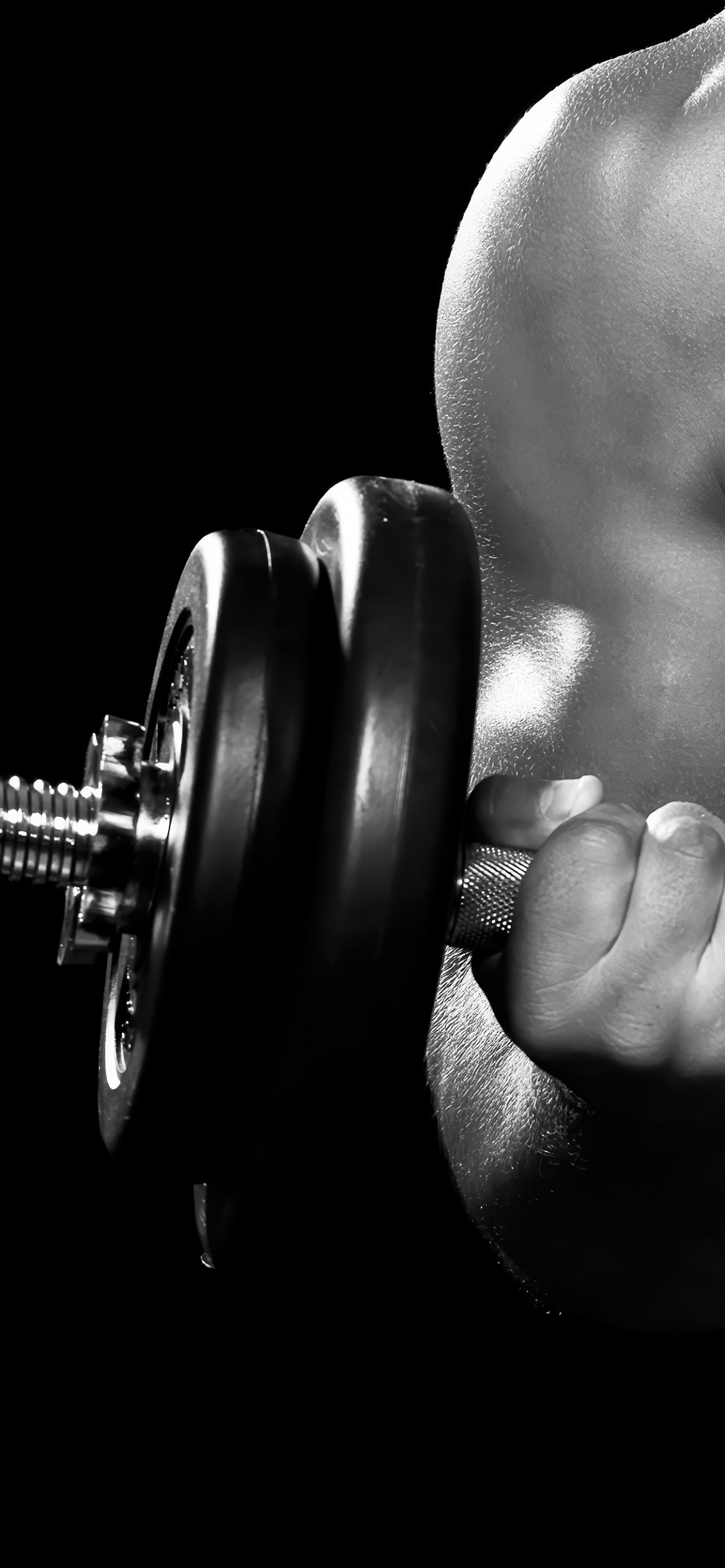 Close-up of a person lifting a dumbbell with a textured grip, focusing on their hand and upper body muscles.