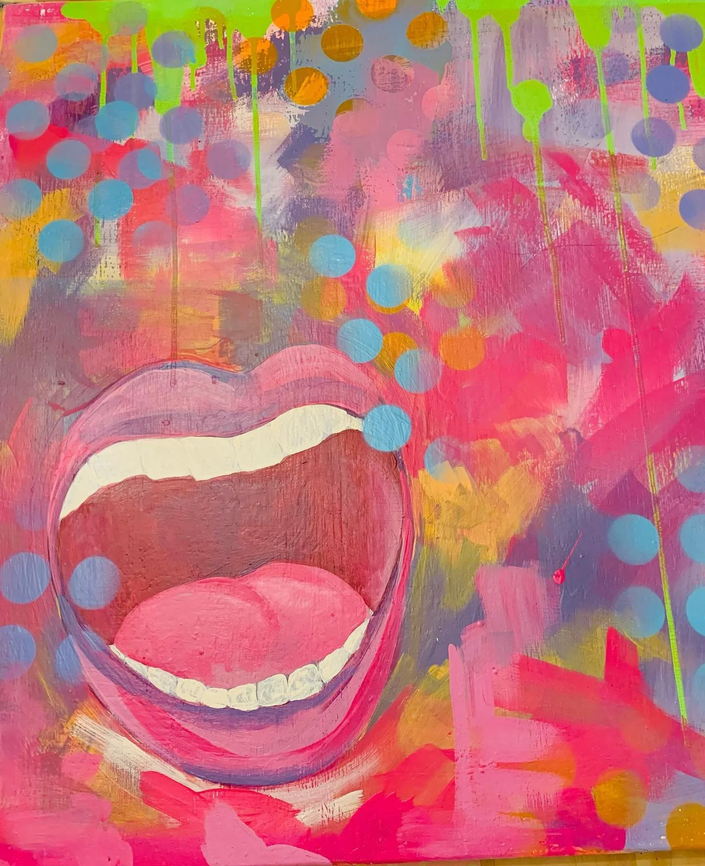 An abstract painting featuring a large open mouth with colorful lips and white teeth, set against a vibrant multicolored background with circles, drips, and splashes of pink, purple, yellow, green, and blue.