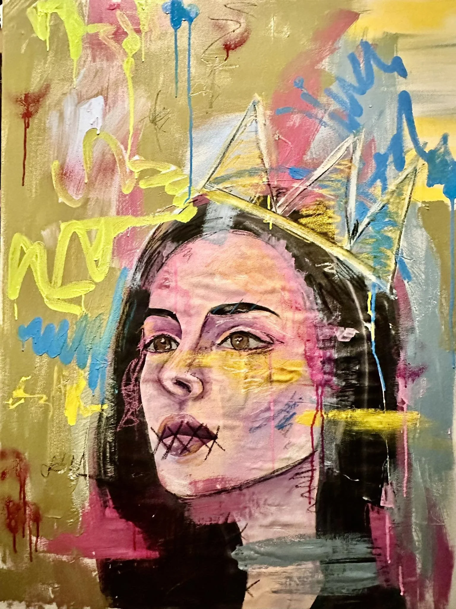 Abstract portrait of a young girl with dark hair and brown eyes, painted in a mixed media style with vibrant colors, bold strokes, and dripping paint. The face has a stencil-style mouth with Xs, and the background features expressive scribbles and splashes of pink, yellow, blue, and gold.