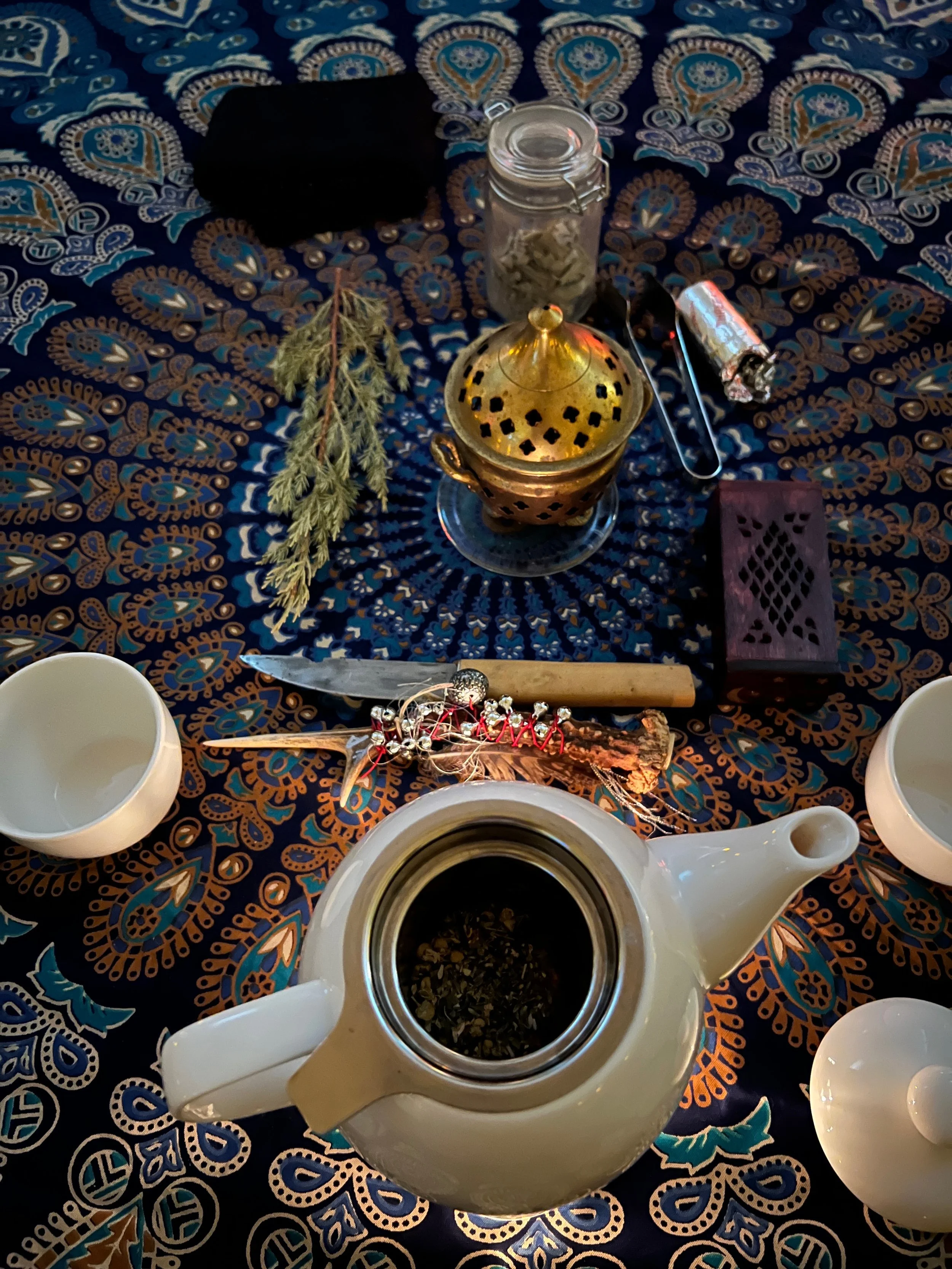 Shamanic 1:1 session set up with tea and shamanic attributes of Unura Kam.