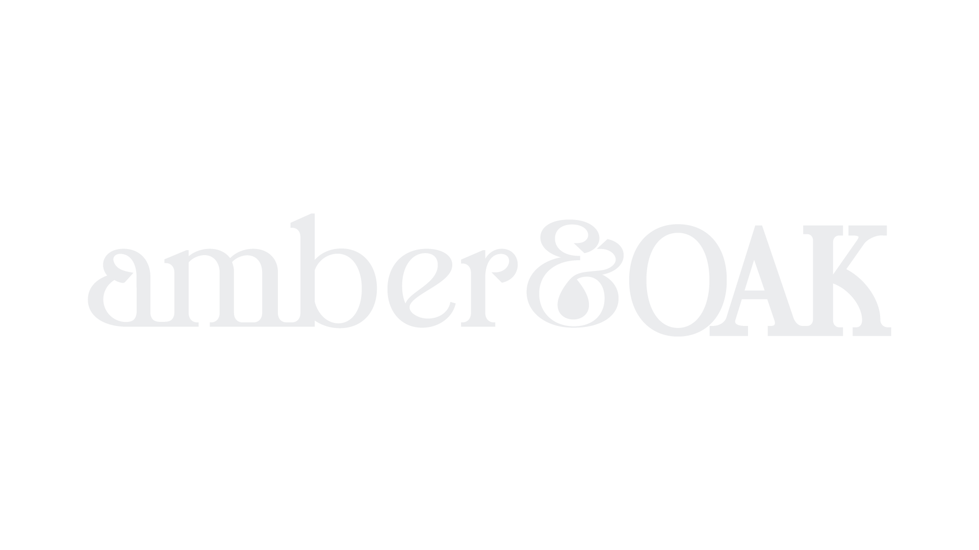 The logo for Amber & Oak, with the words 'amber & OAK' in light gray text on a black background.