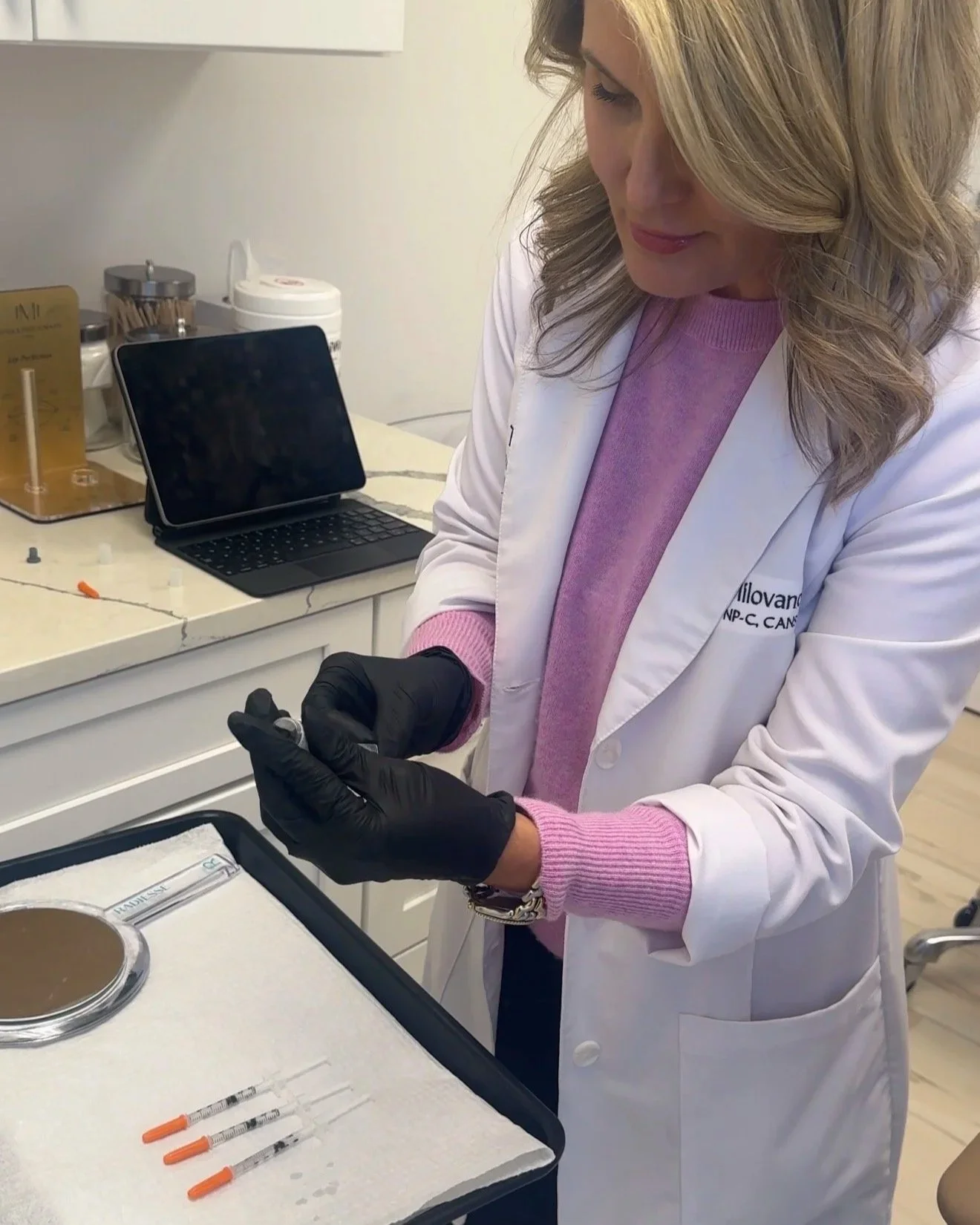 Medical provider preparing injectable treatment at The Concierge Clinic.