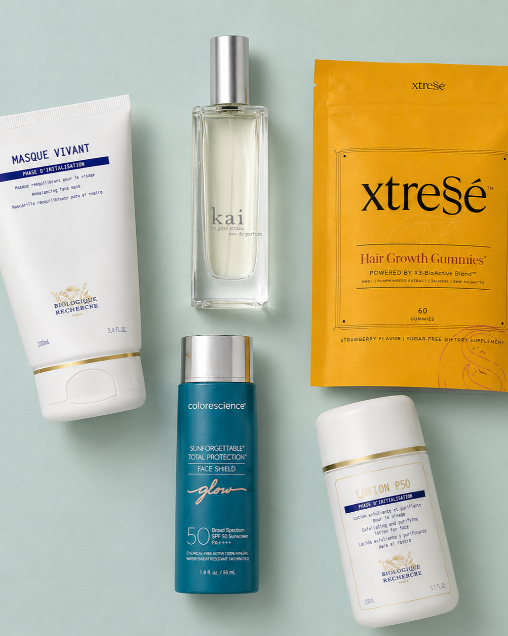 Assorted skincare and hair care products on a light blue background, including face masks, sunscreen, a perfume spray, hair gummies, and a lotion.