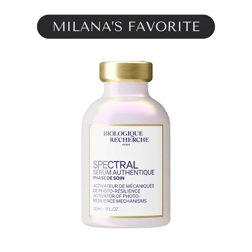 A white cosmetic bottle with a gold cap, labeled 'Biologique Recherche Spectral Series'. The label indicates it is a photo-resilience activating serum from Paris. The background features a black banner with white text that says 'Milana's Favorite'.