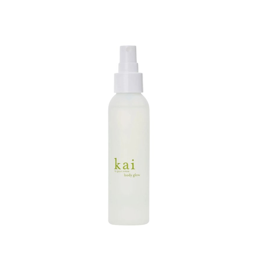 A white spray bottle labeled 'kai body glow' with a spray nozzle on top.