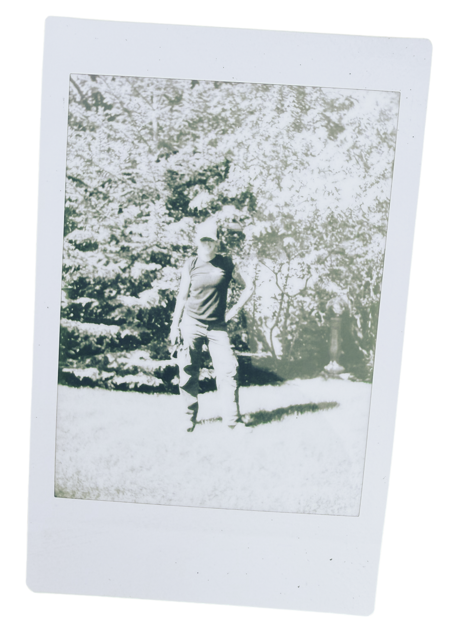 Black and white photograph of a woman, Jen, who runs a garden maintenance business in Calgary, standing with trees and foliage in the background.