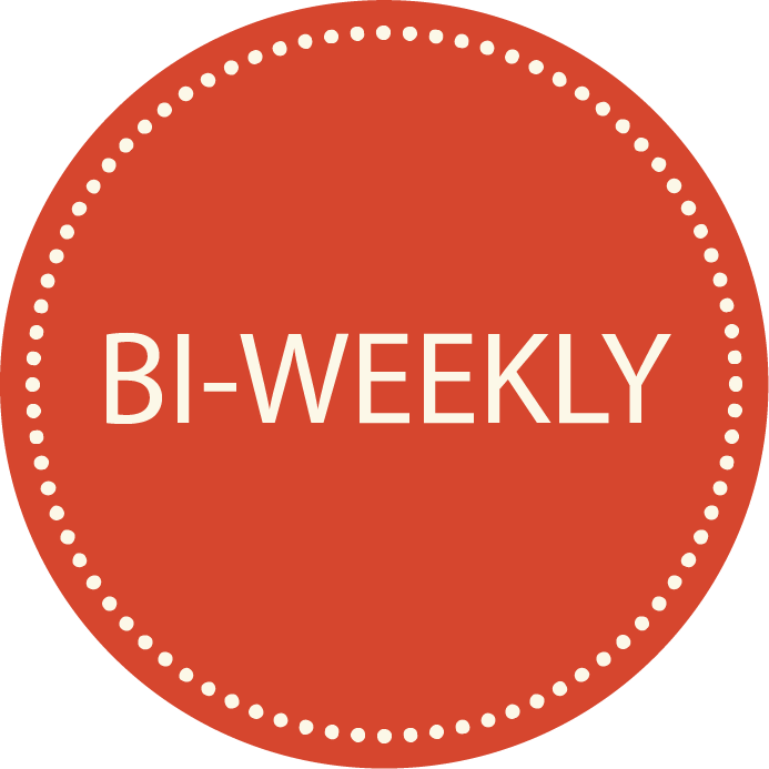 A circular badge with a red background and white dotted border, containing the text 'B-WEEKLY' in white capital letters.