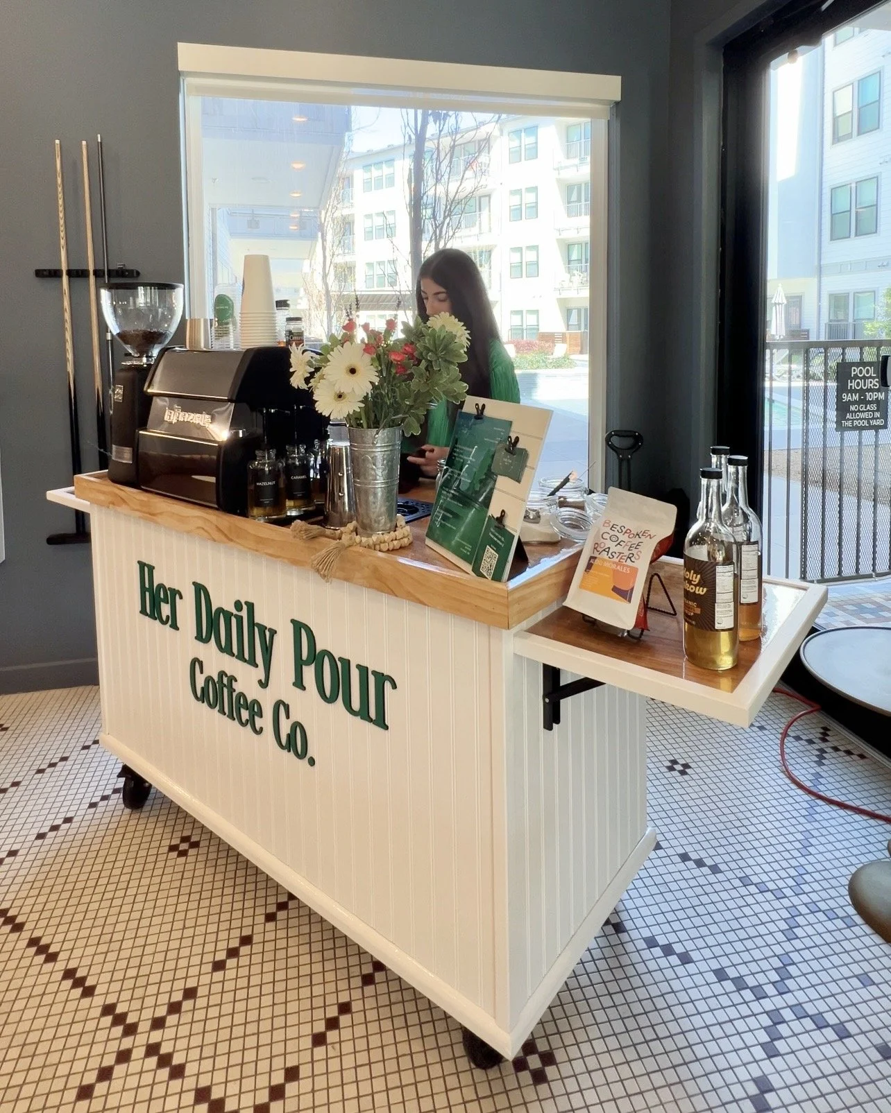 A mobile coffee cart with a professional barista behind the espresso bar serving espresso based drinks at a private event in Bend, Oregon