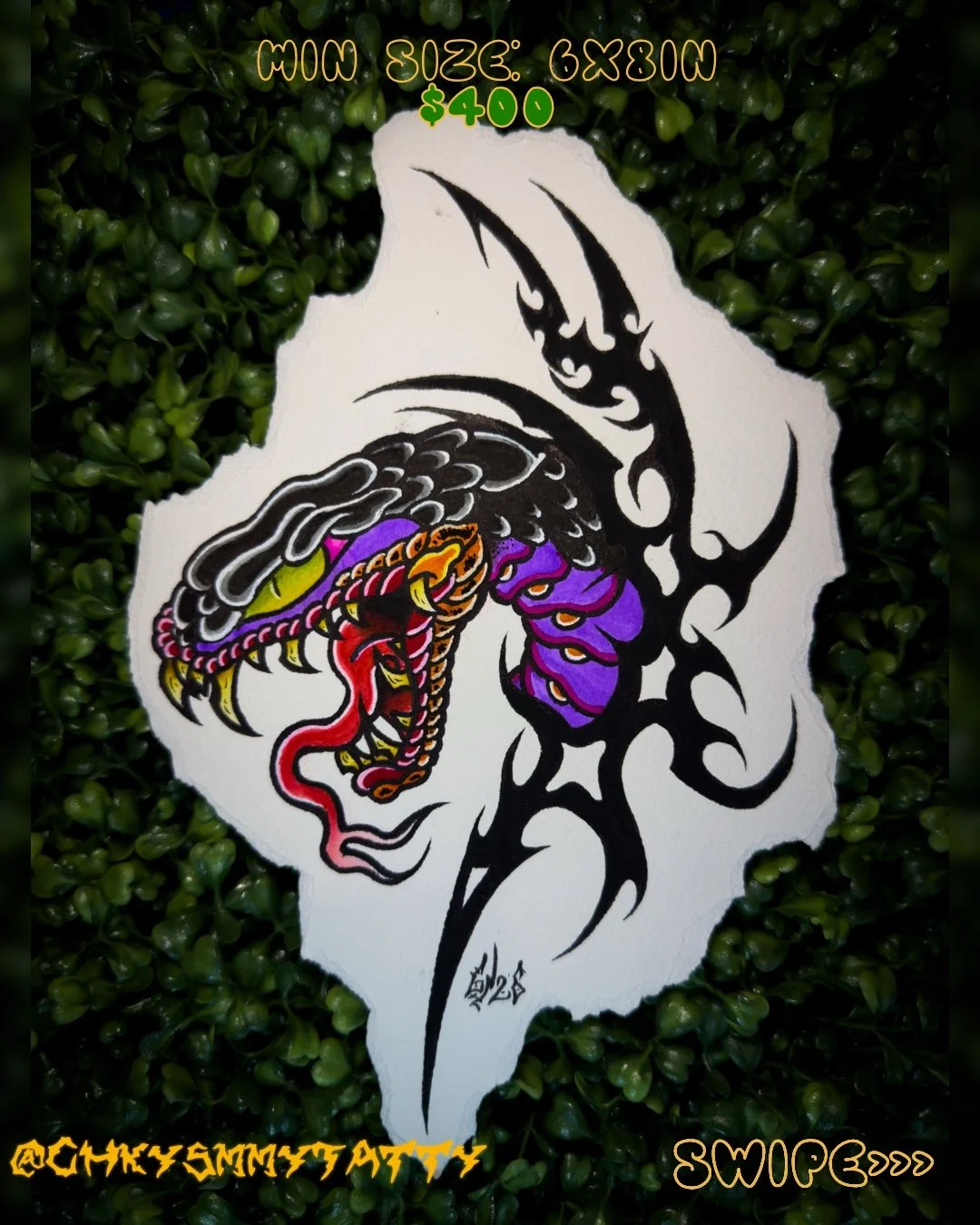 A tattoo design on paper featuring a dragon with purple and orange accents, black tribal elements, and a stylized face. Greenery surrounds the paper.