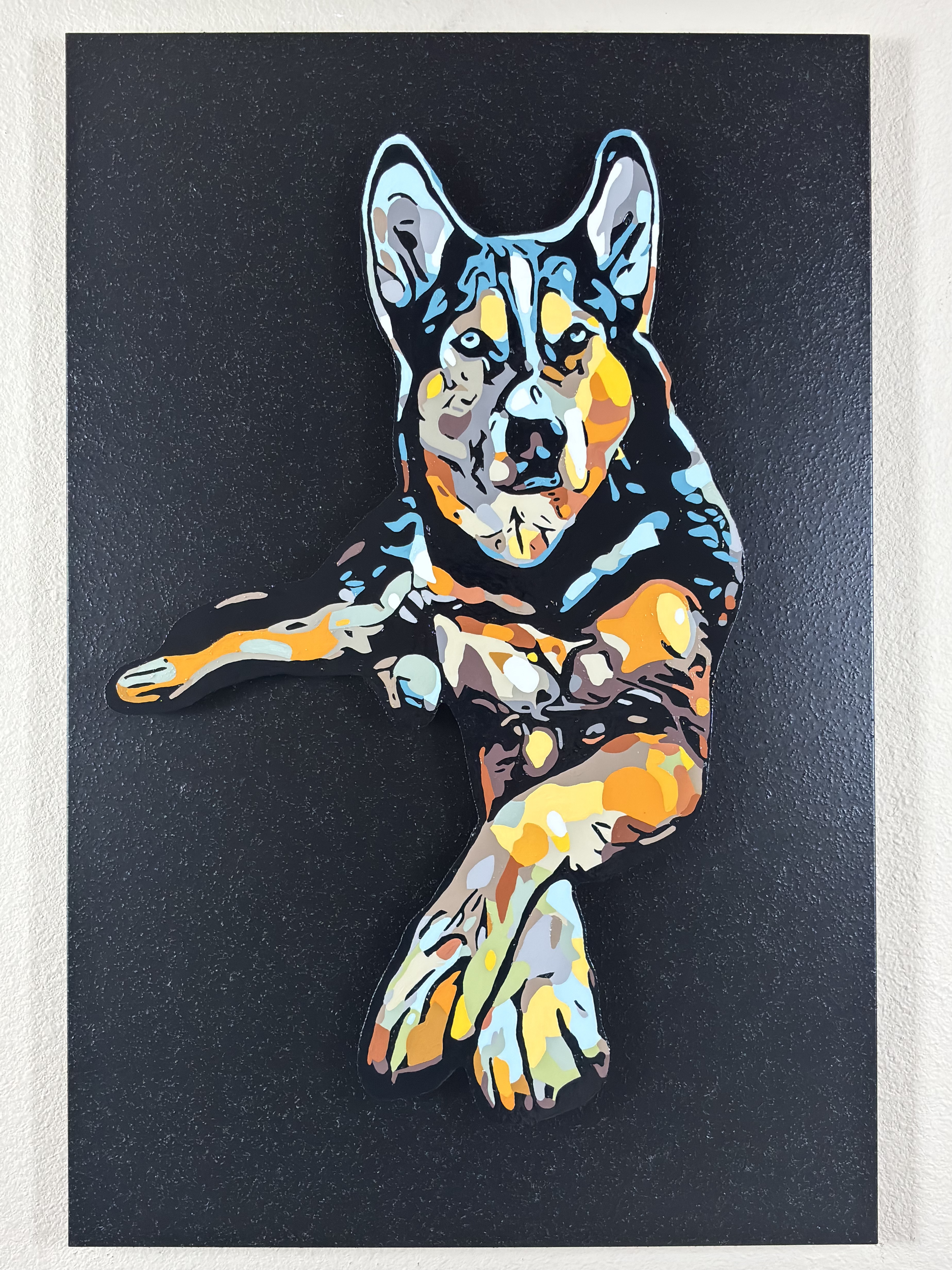 Colorful painting of a dog lying down, with a black background.