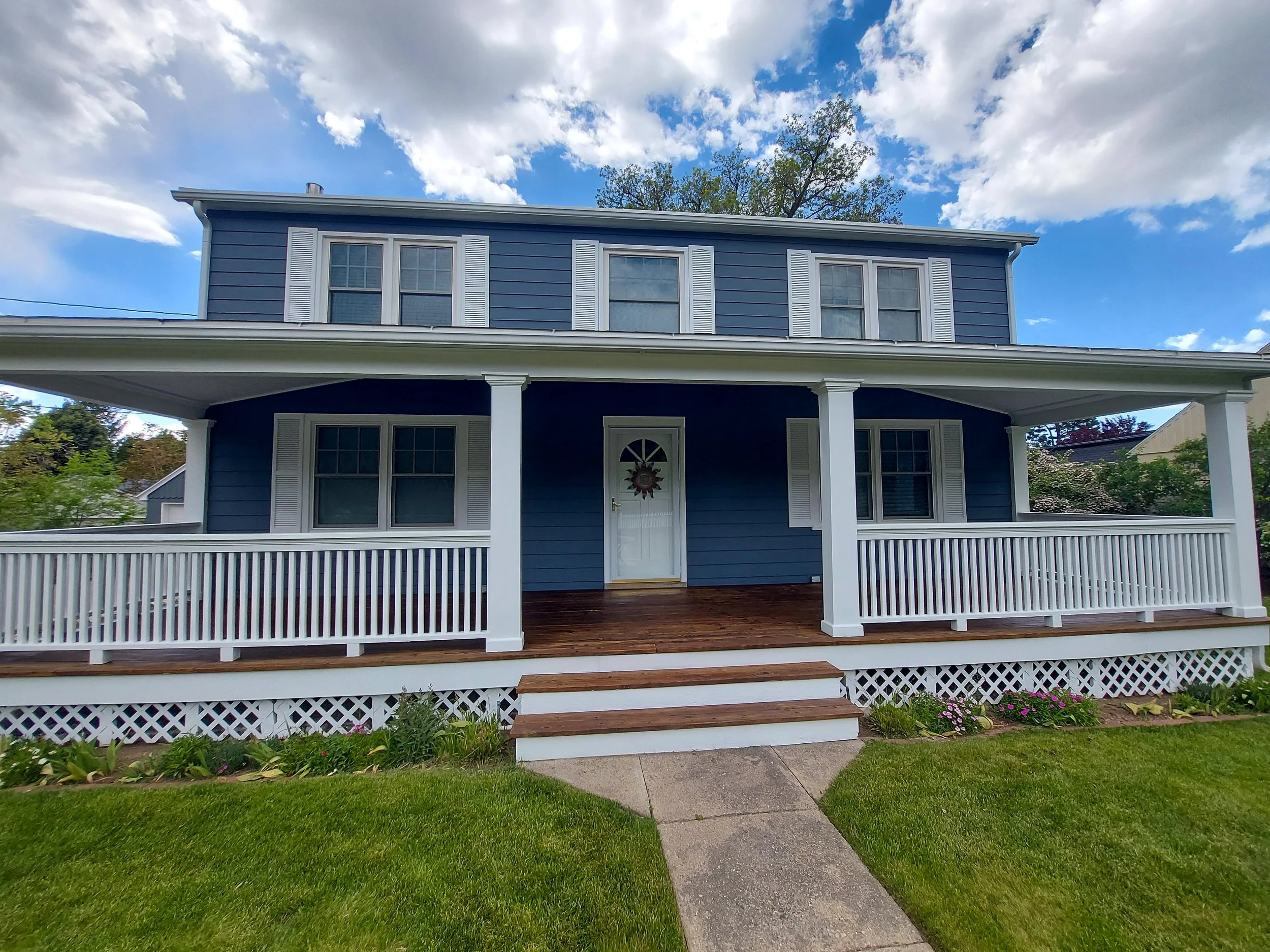 Exterior house with wood siding painted and deck sealed