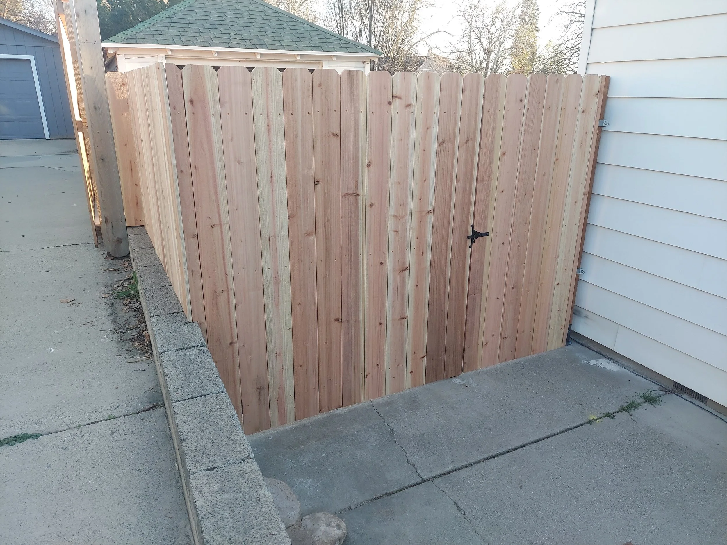 Outside of a new cedar fence and gate build