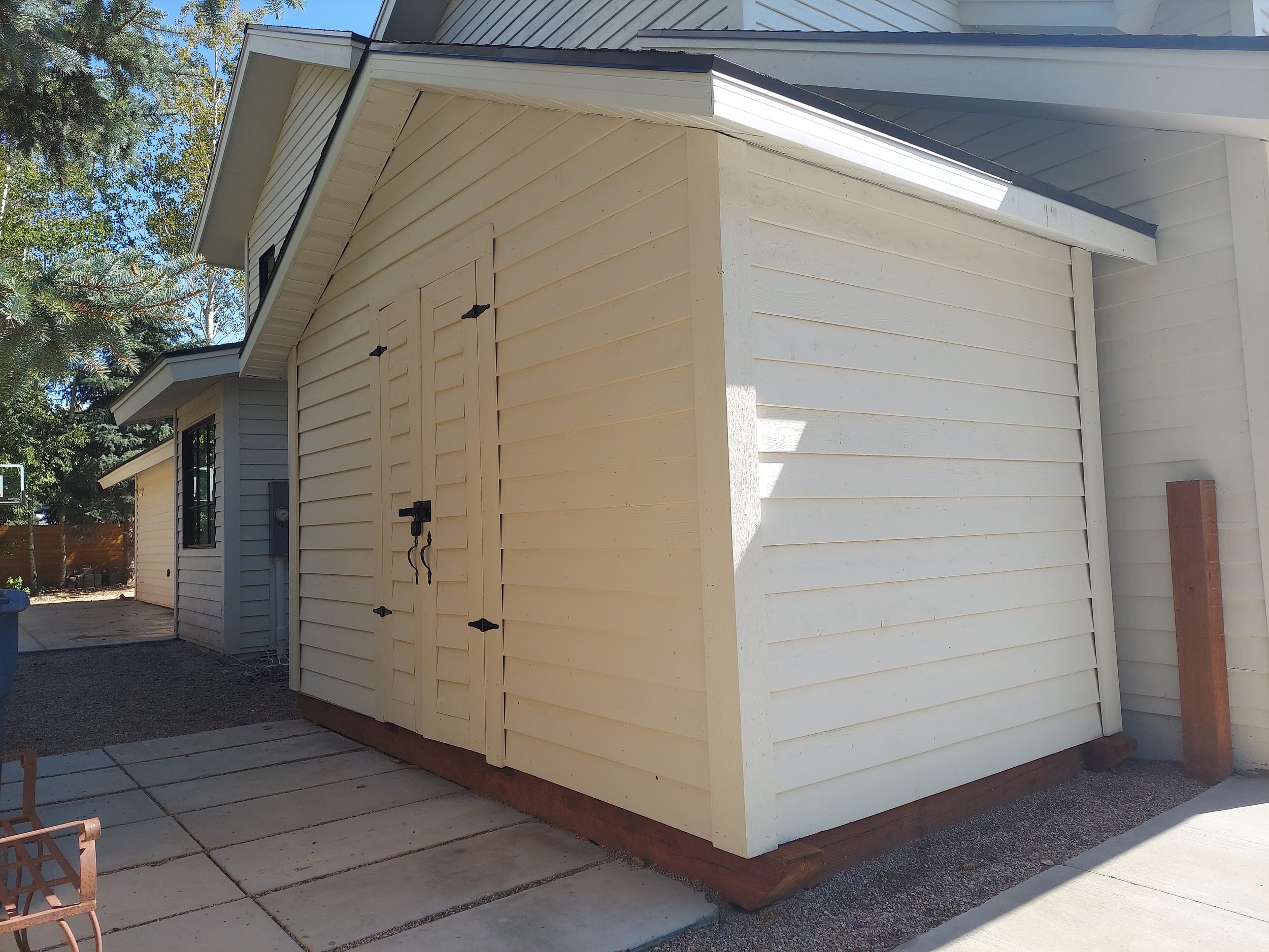Cedar wood shed after solid stain to match the house