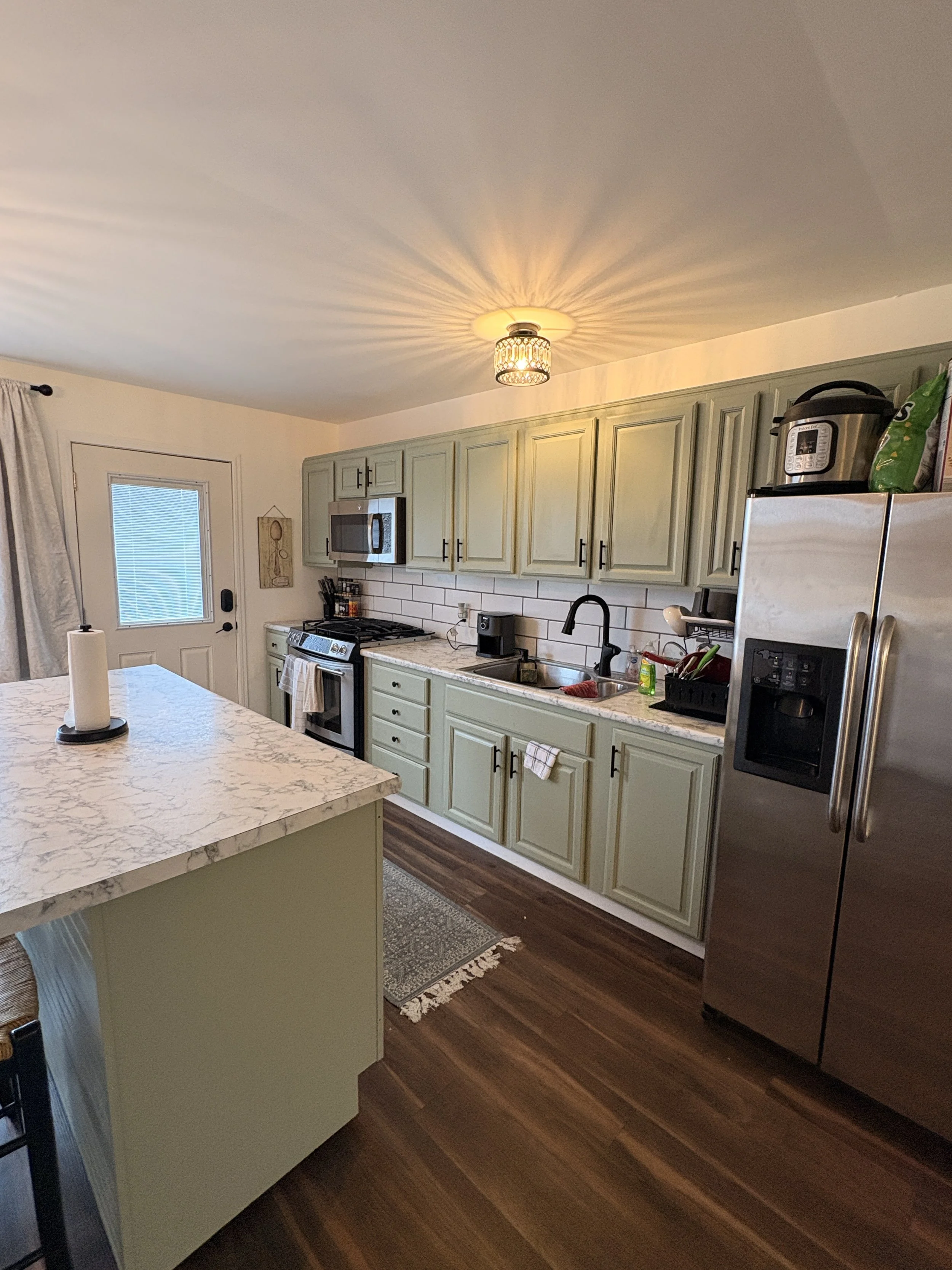 modern kitchen with green cupboards