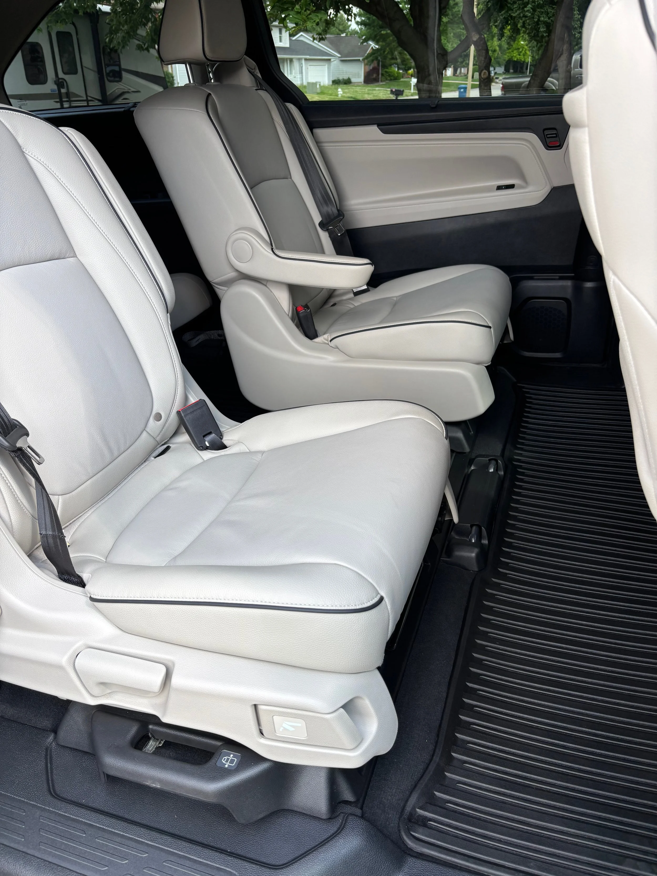 Cleaned and conditioned light grey leather captain seats and rubber floor liner in minivan Springfield IL