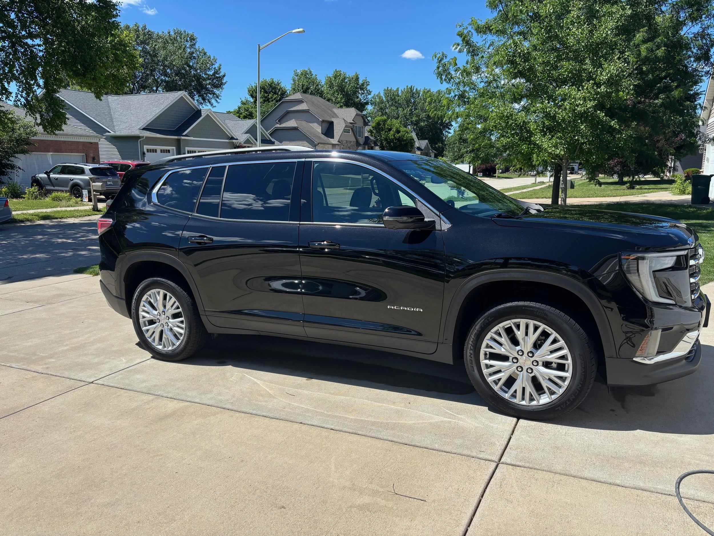High gloss paint sealant and wheel detail on black GMC Acadia SUV in Springfield IL