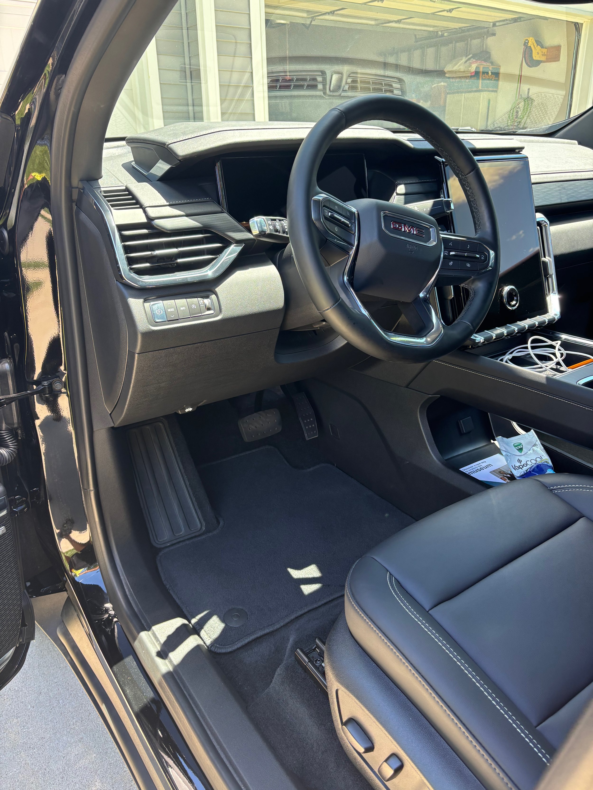 Clean black leather driver seat dashboard and WeatherTech floor mat Springfield IL