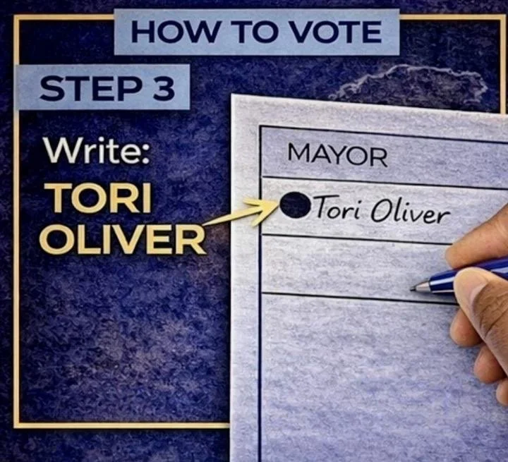 A sign showing the instructions for voting, with step 3 instructing to write 'Tori Oliver' on the ballot sheet for mayor, and an actual ballot sheet with a hand writing 'Tori Oliver'.