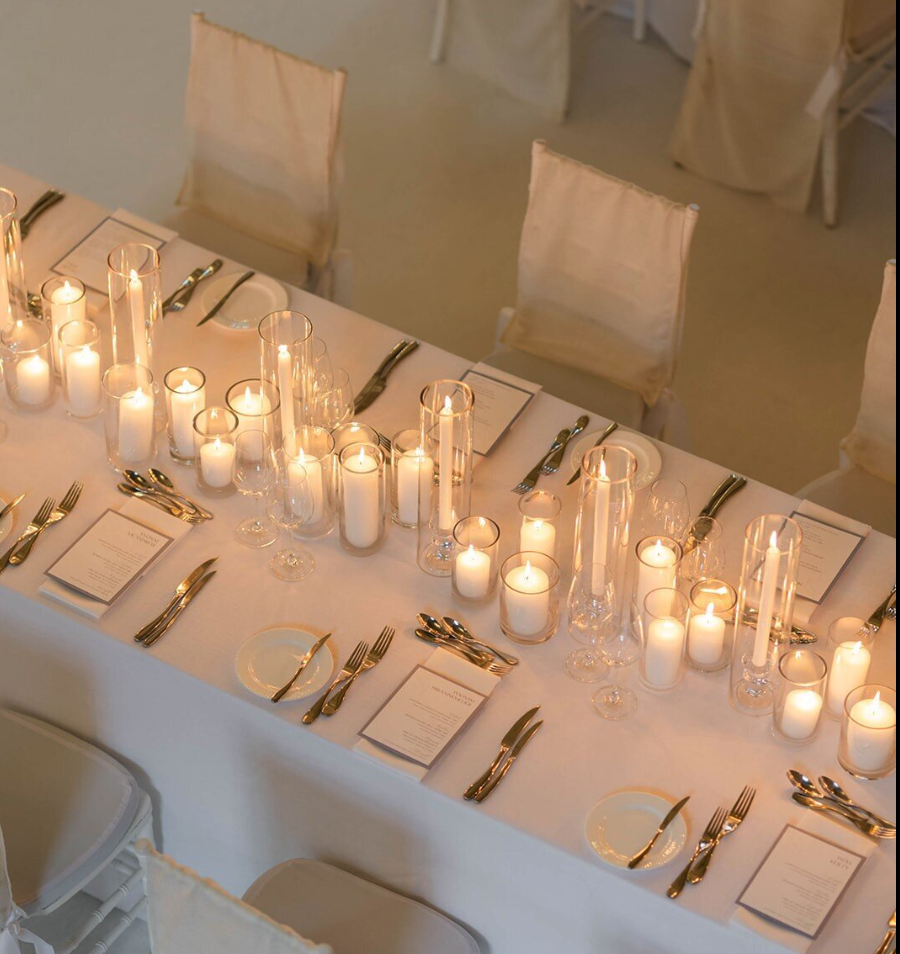 Luxury candlescape on a guest table for a wedding reception.