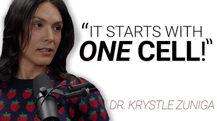 A woman speaking into a microphone, wearing a dark sweater with red strawberries, with the quote 'It starts with one cell!' and the name Dr. Krystle Zuniga.