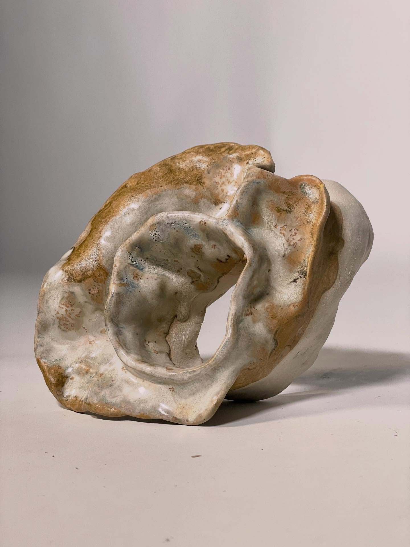 Hollow Whisper

Stoneware with glaze
2025

This vessel whispers an unfamiliar tale, her voice tentative, yet her body speaks in truths. She has endured beyond her years; the universe has etched its wisdom into every fold. Layered, weathered, luminous