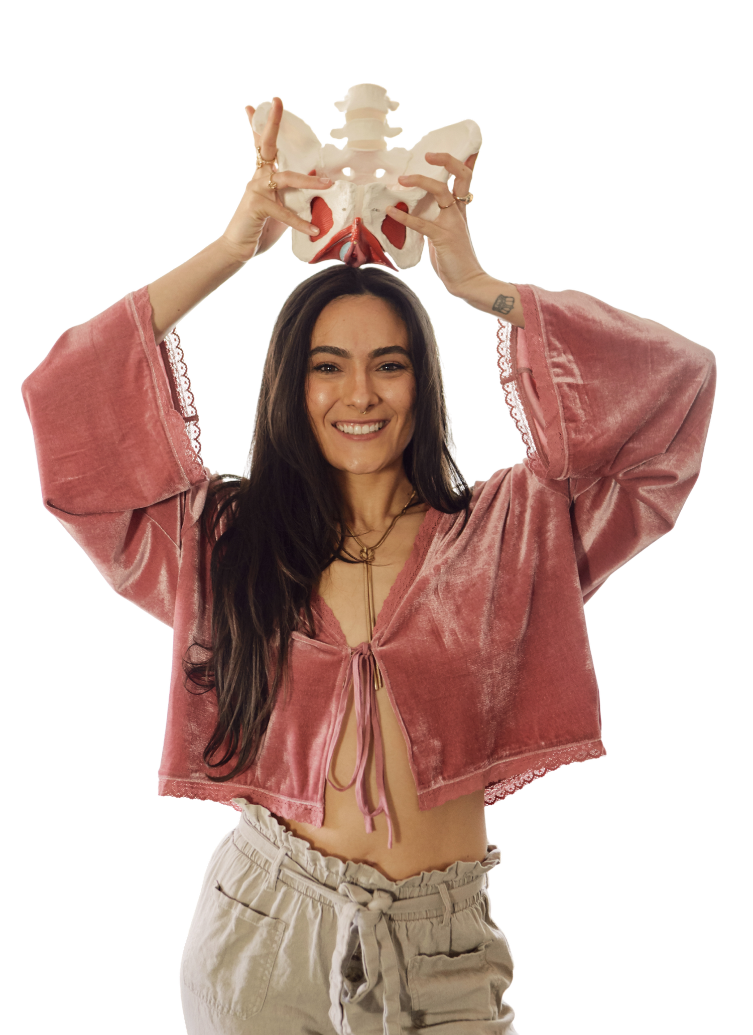 Haley smiling with both hands holding an anatomical pelvis above her head