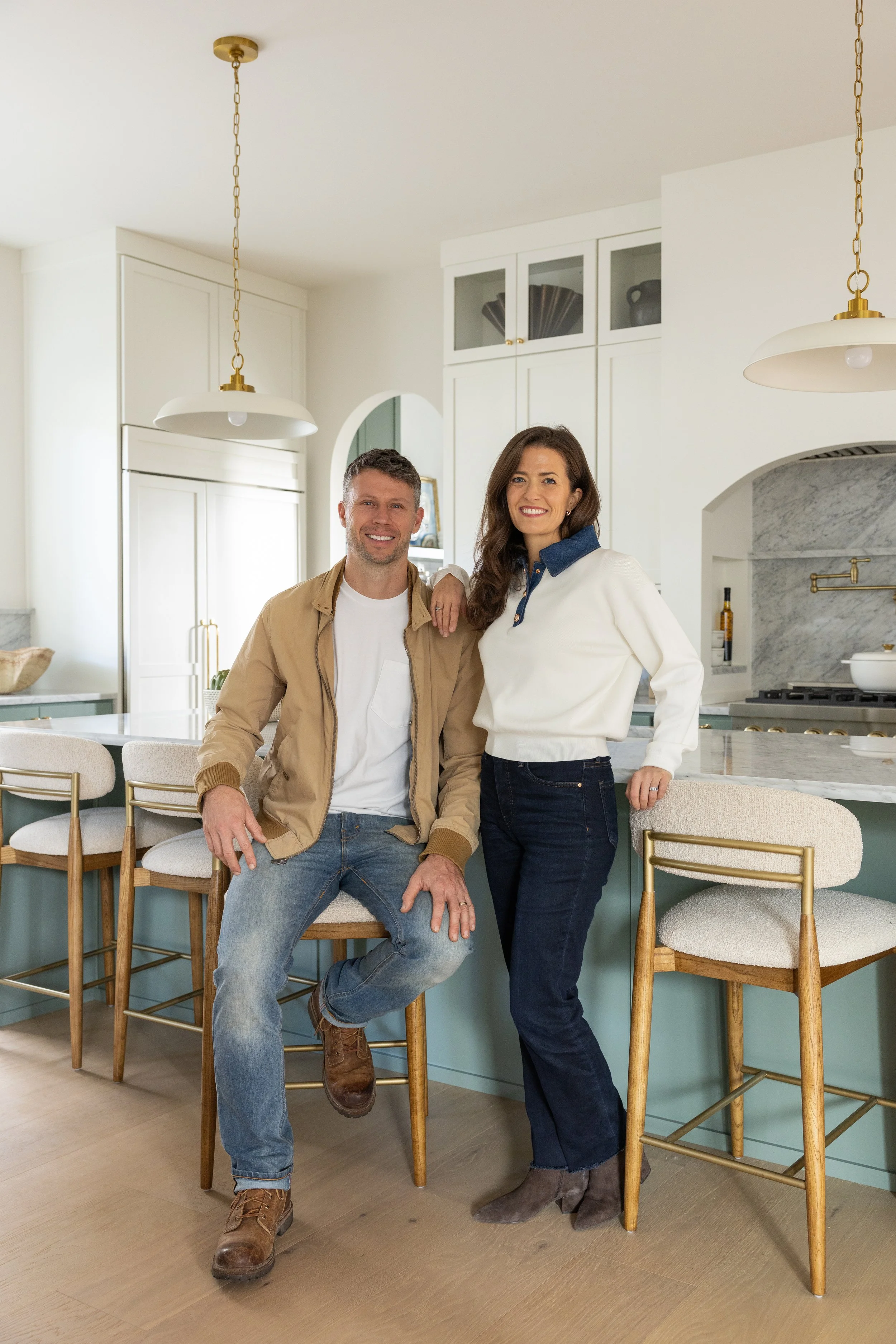 Husband and wife design and builder team. Kitchen with barstools and marble countertop. Building team. Seattle Builders.