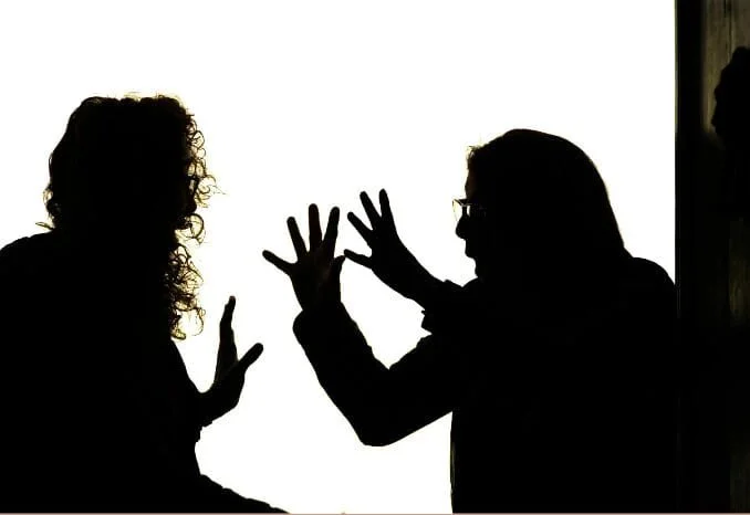 Parent and teenager experiencing emotional conflict, stress, and communication struggles at home