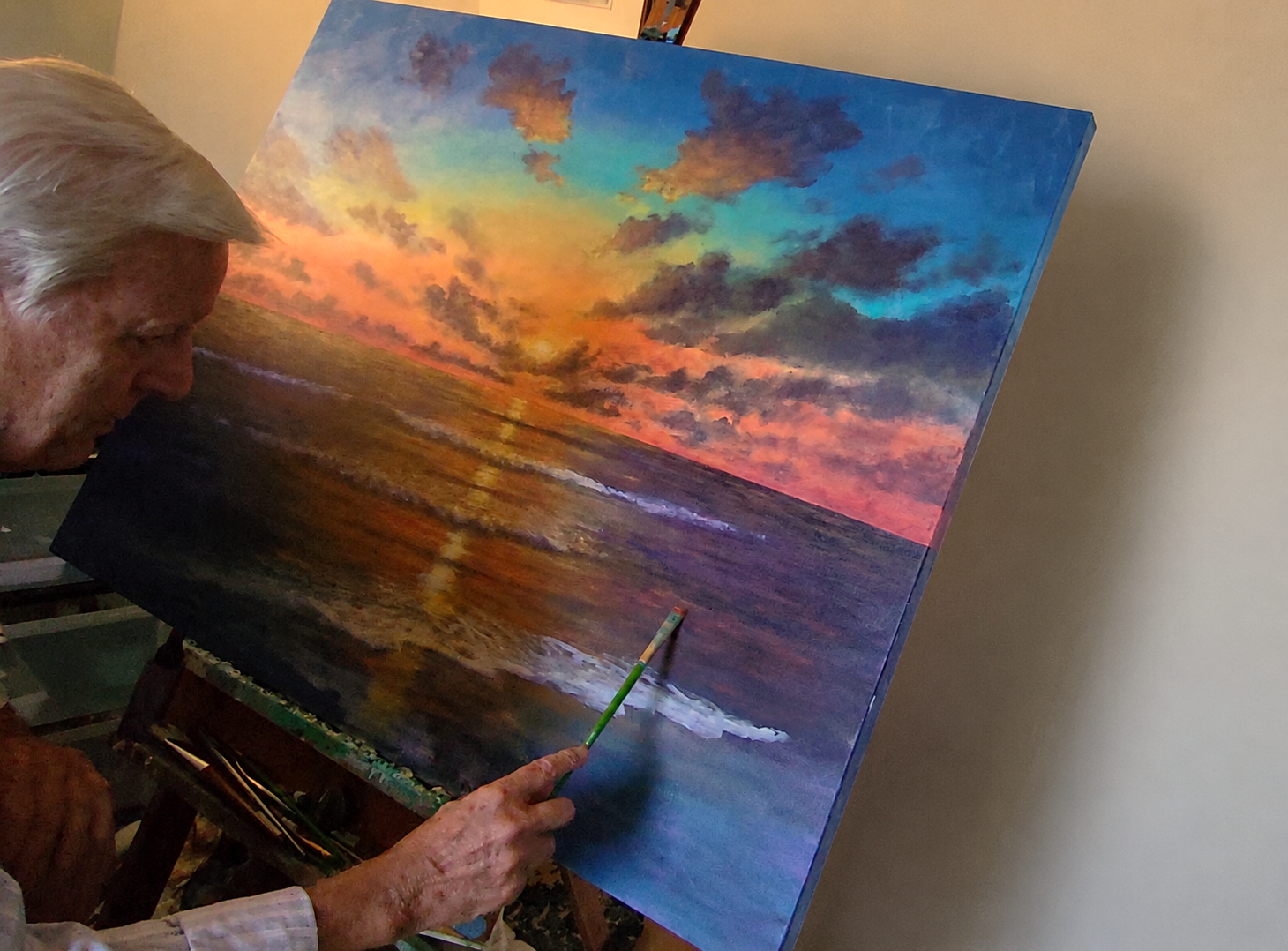 Alan Zawacki working on sunset painting in studio.png