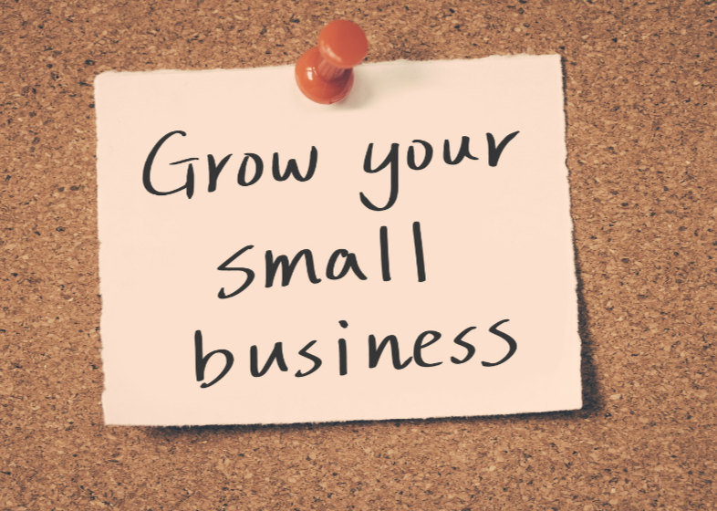 Note pinned on corkboard with the message 'Grow your small business.'