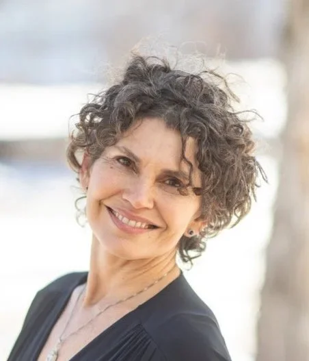 Smiling woman with short curly hair outdoors