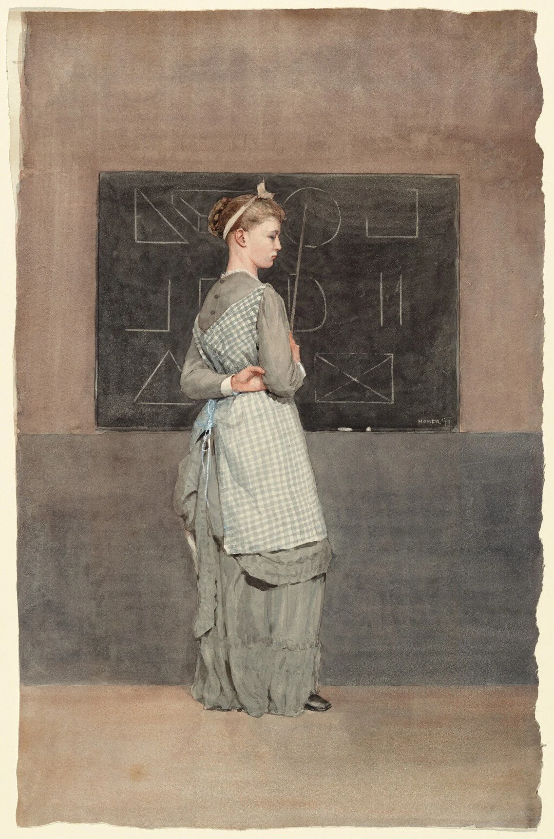 A woman in vintage clothing with a checked apron stands in front of a black chalkboard with geometric sketches in a classroom.