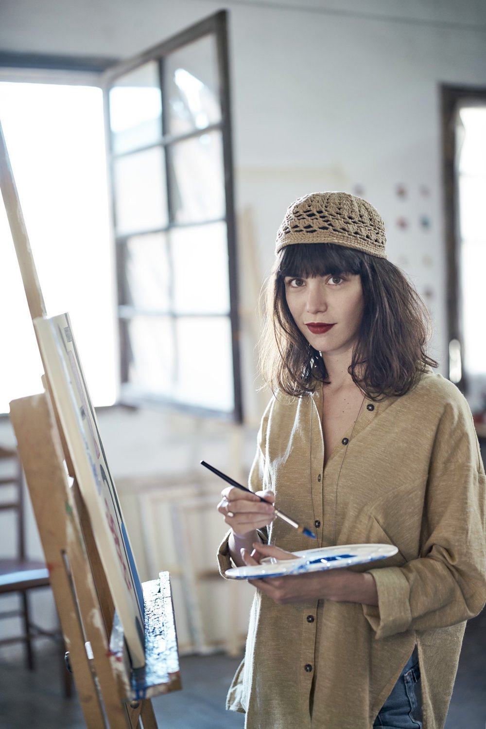 artist blanca miro with a paintbrush in hand