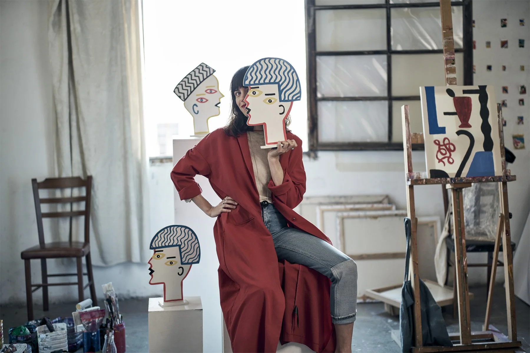 artist blanca miro holding a sculpture of a head in front of her face