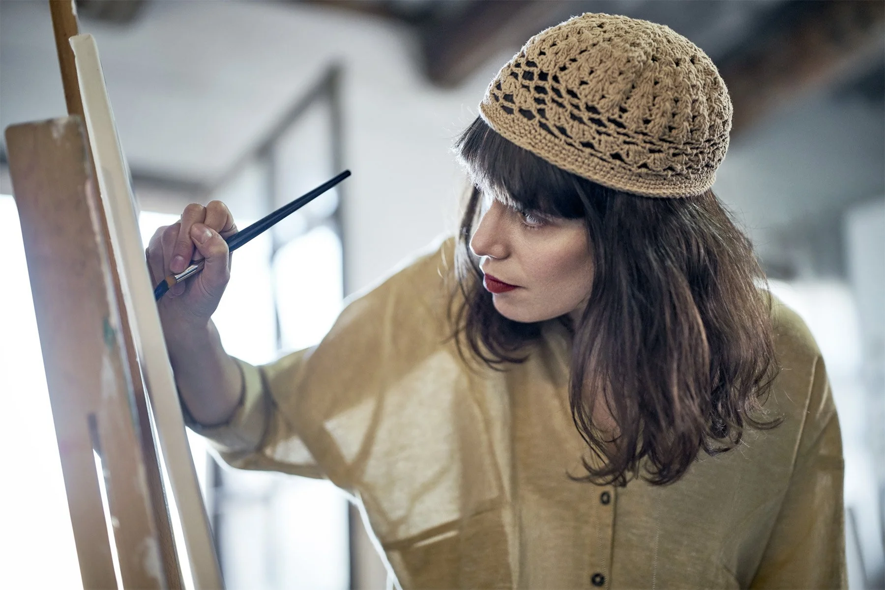 artist blanca miro painting onto an easel