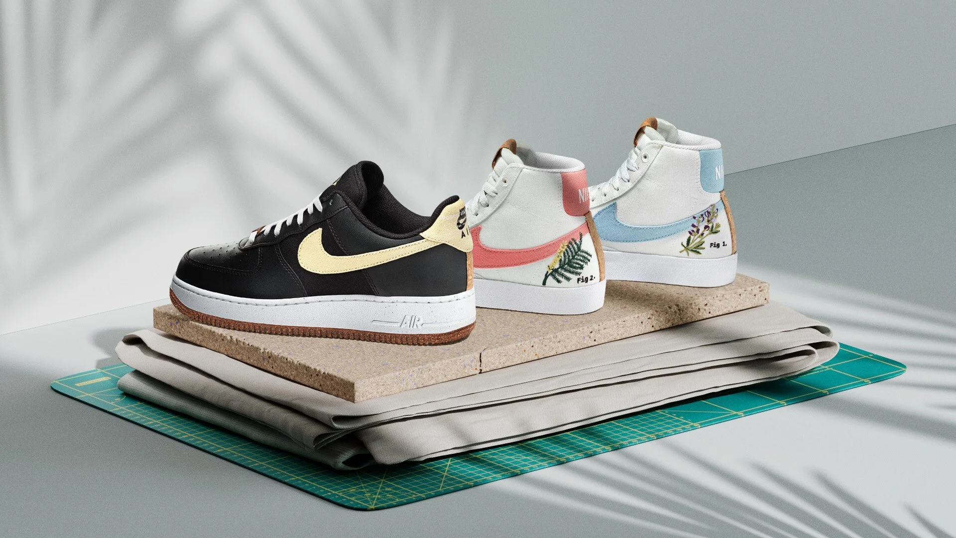 three nike hightop sneakers on a cork board