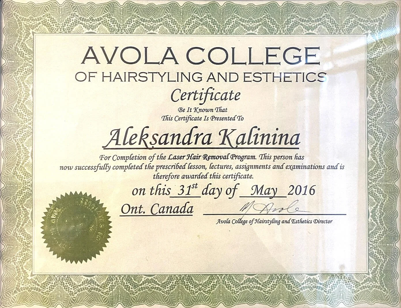 Certificate from Avola College of Hairstyling and Esthetics presented to Aleksandra Kalinina for completing the Laser Hair Removal Program, dated May 31, 2016, with a gold seal at the bottom left.