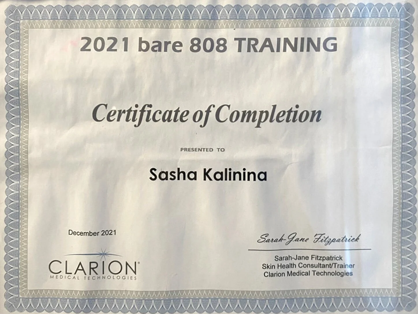 Certificate of completion for Sasha Kalina from the 2021 bare 808 training program, issued in December 2021 by Clarion Medical Technologies, signed by Sarah-Jane Fitzpatrick, a skin health consultant and trainer.