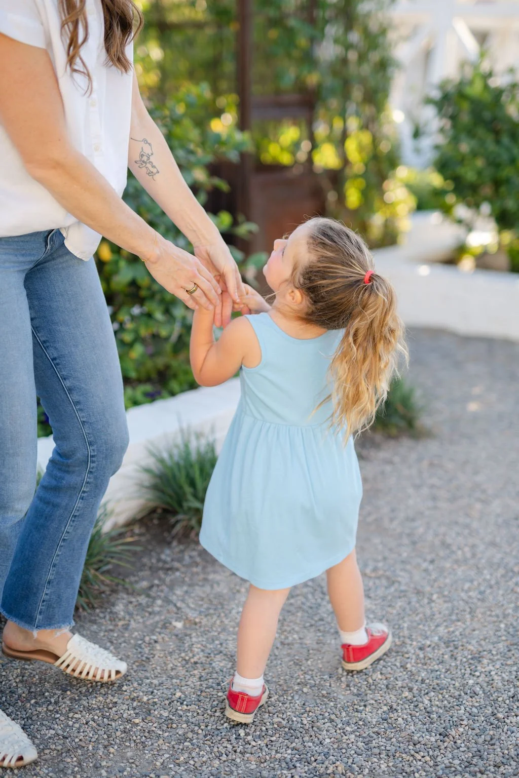 Mother and young child holding hands