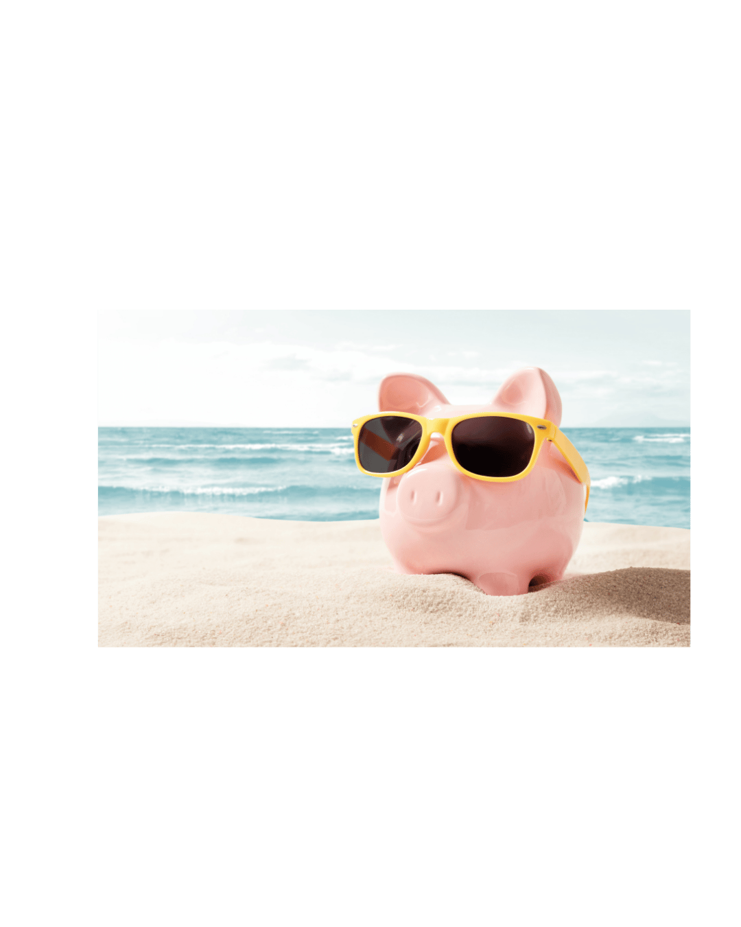 Pink piggy bank wearing yellow sunglasses on a sandy beach with ocean waves in the background.