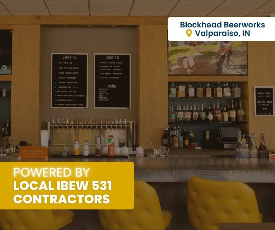 Bar with drink supplies and menu boards; yellow chairs in foreground; sign indicating location in Valparaiso, IN, powered by local IBEW 531 contractors.