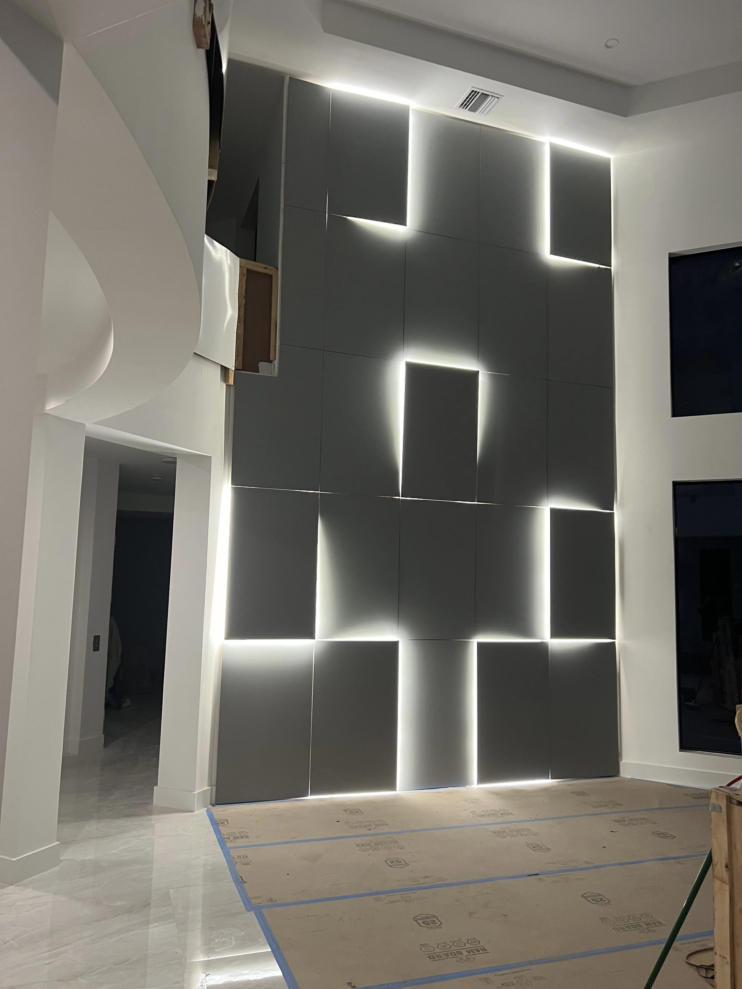 Geometric panels with integrated LED lighting create depth, contrast, and a striking modern focal point.