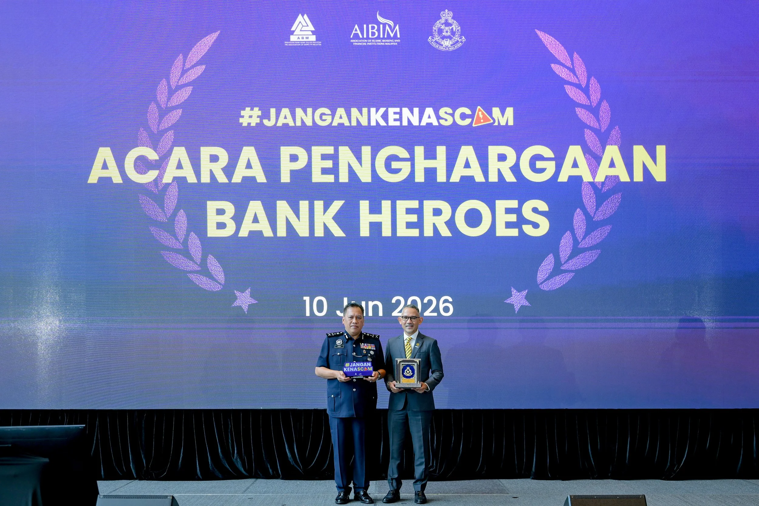 Malaysian bank staff receiving recognition for preventing financial scams