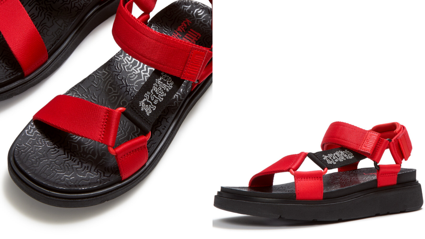Close-up of FitFlop x Keith Haring footwear with graphic red straps and pop art details.
