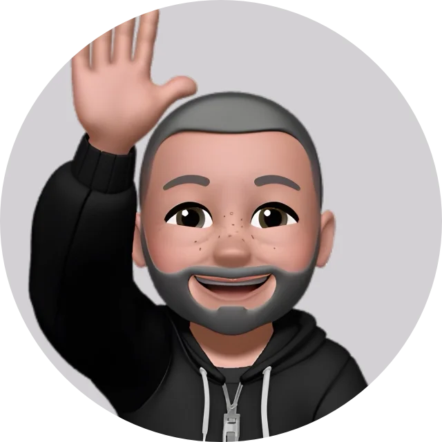 A cartoon avatar of a man with a beard and short hair, smiling and waving, wearing a black hoodie.