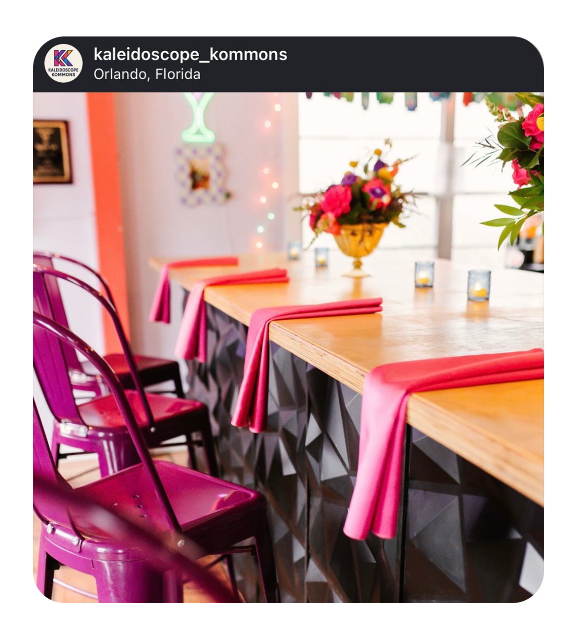 an Instagram post screenshot of Kaleidoscope Thornton Park with a long wooden table, pink napkins, purple metal chairs, a floral centerpiece, candle votives, and colorful wall decor in Orlando, Florida.